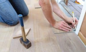 Person measuring flooring material