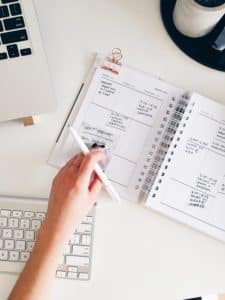 person writing in a planner