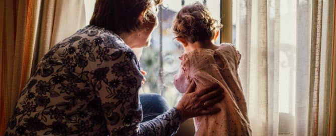 Grandma and granddaughter looking out the window